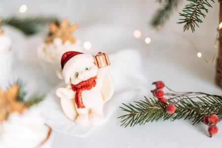 Christmas chocolate bunny in front of Christmas tree branches and garlandsの写真素材