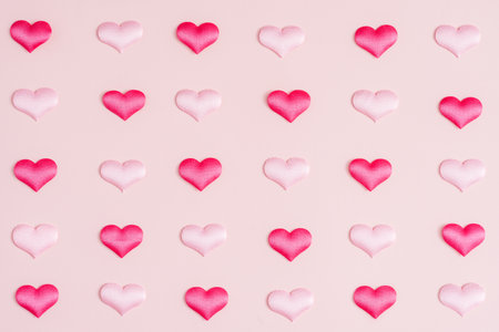 Background pattern pink and red heart on peach colored paper