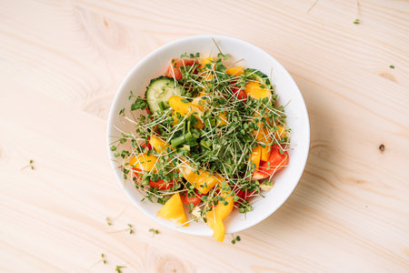 Vegetable salad with microgreens on wooden tableの写真素材