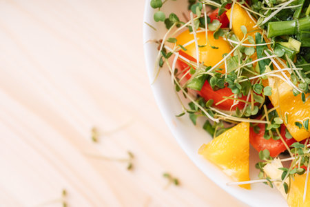 Vegetable salad with microgreens on a wooden tableの写真素材