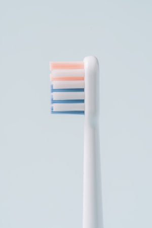 Electric toothbrush head in profile against blue backgroundの写真素材