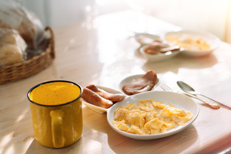 Childrens plate in the form of hare for separate meals. Childrens breakfast with omelet and fried sausagesの写真素材