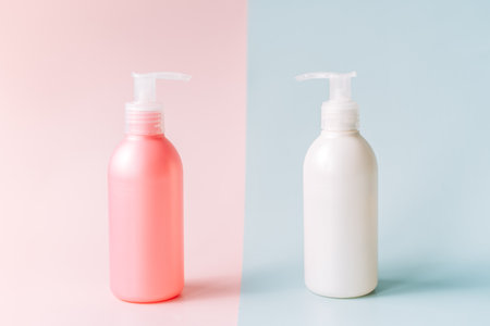 Tubes with dispenser against pink and blue backgroundの写真素材
