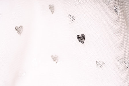 White background of tulle on tulle with glittering heartsの写真素材