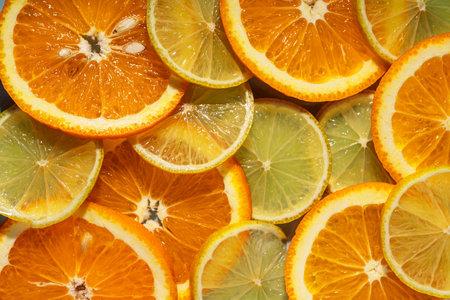 Background of round cut citrus fruits orange and lemonの写真素材