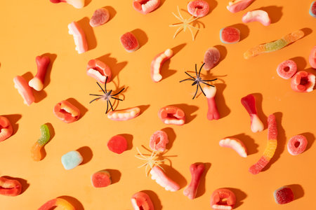 Marmalade in the form of fangs and bones for halloween on an orange backgroundの写真素材