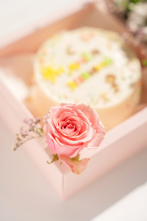 Cake with an inscription with blooming roses in pink gift boxの写真素材