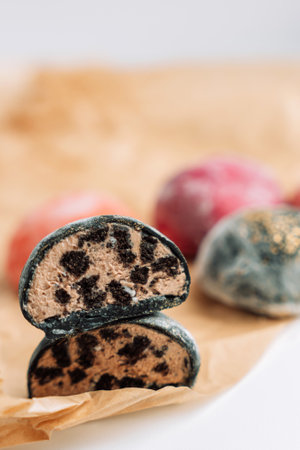 Half colored mochi on wooden board on white background