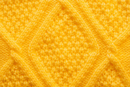 Background of striped knitted sweater in yellow colorの写真素材