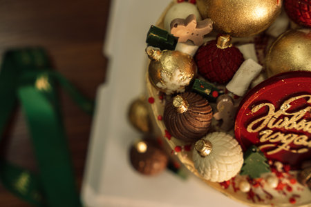 Layer cake with chocolate decorations in the shape of Christmas tree decorationsの写真素材