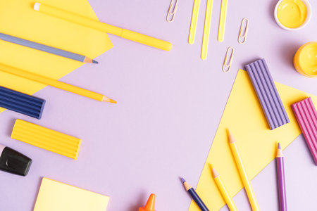School stationery scattered on purple backgroundの写真素材