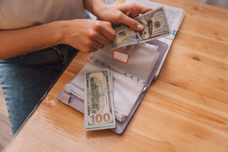 Putting money into different zip bags in a notepad