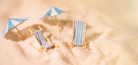 Striped sunbeds and umbrellas on the yellow clean sand of the beachの写真素材