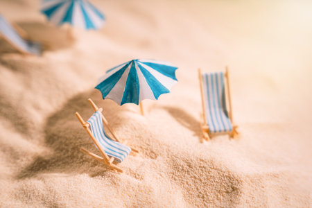 Striped sunbeds and umbrellas on the yellow clean sand of the beachの写真素材
