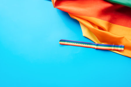 LGBT flag and wrist strap on blue background