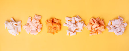 Bunches of snus bags with different flavors and different colors on a yellow backgroundの写真素材