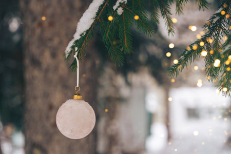 bauble on christmas tree with snow outdoorの写真素材