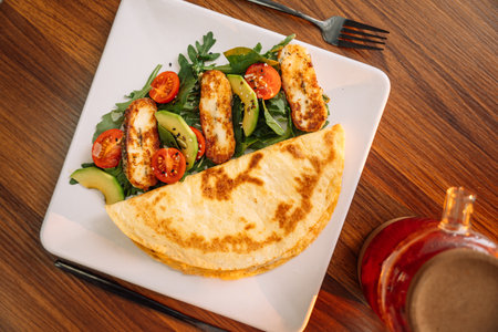 Tortilla with salad in a square white plateの写真素材
