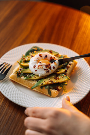 waffles with poached egg avocado on plate on wooden background.の写真素材