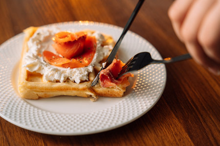 Belgian waffles with salmon on wooden background, breakfast, red fish.の写真素材