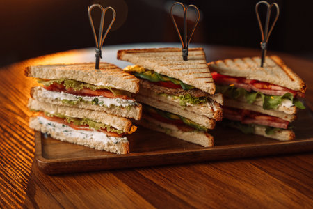 Different types of sandwiches with skewers grilled on the table