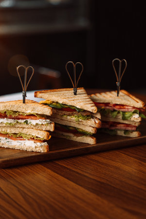Different types of sandwiches with skewers on the table