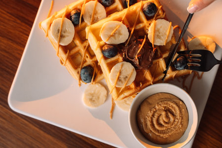 Sweet waffles with bananas, and berry jam for breakfast.の写真素材