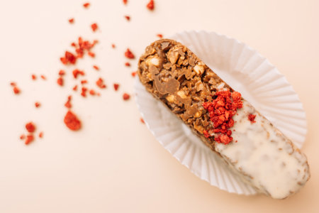 Dessert chocolate bar made at home, milk chocolate with nuts, Sublimated raspberries next to each...