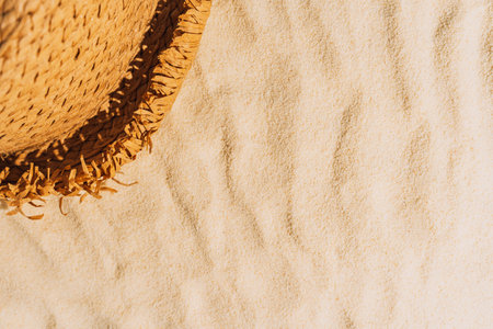 summer background of beach sand with hatの写真素材