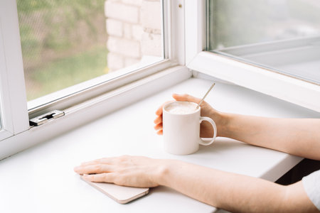 Woman enjoying a peaceful moment with coffeeの写真素材