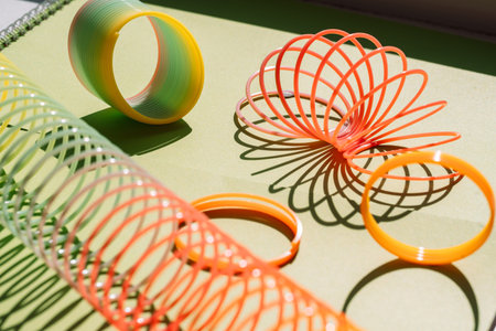 Colorful slinky toys on green surface