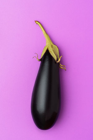 Eggplant isolated on violet background, fresh vegetableの写真素材