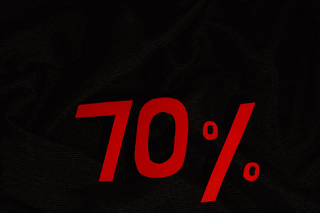 Red 70 percent on black fabric backgroundの写真素材
