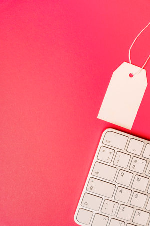 Blank price tag with mouse and keyboard on pink background cyber sale conceptの写真素材