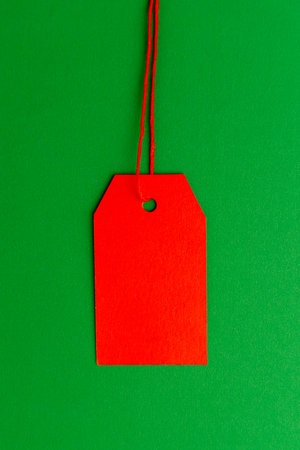 Red price tag on green background minimal compositionの写真素材