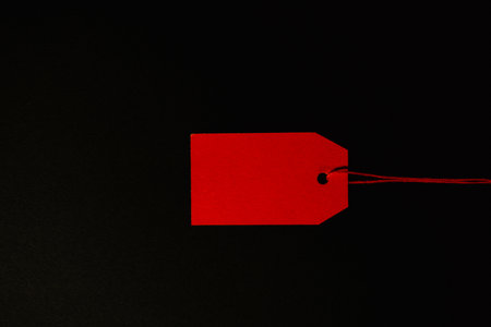 Red sale tag on black background, wide bannerの写真素材