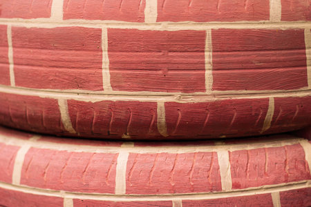 Painted tire surface with handmade brick texture closeup