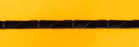 Macro of RAM gold contacts on bright yellow background