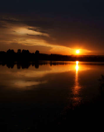 Sunset on the river warm summer evening.の写真素材
