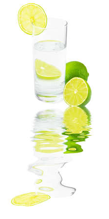 Glass with water ,lime and reflection の写真素材
