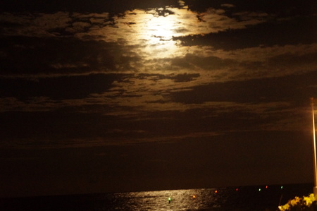 moon over the ocean on a summer nightの写真素材