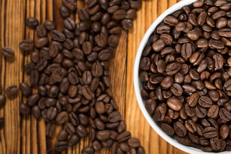 The best beans. The bowl full of roasted coffee beans on a table.の写真素材
