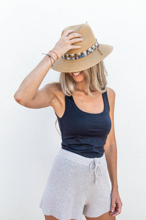 Portrait of caucasian woman with big smile and blonde hair and hatの写真素材