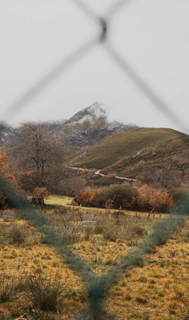 majestic and colorful mountain surrounded by clouds on an autumn dayの写真素材