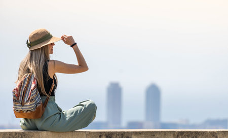 Happy woman with a hat enjoying the views of the city