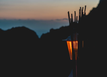 Sunset with candle lamp with orange color with dark space and cloudy skyの写真素材