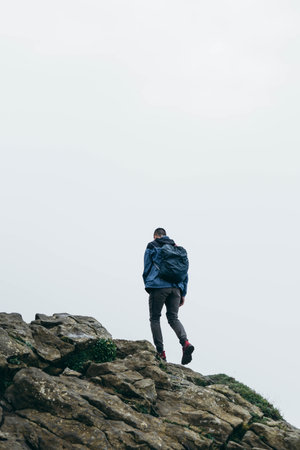 Alone man with equipment in the nature with several fog hiking the mountainの写真素材