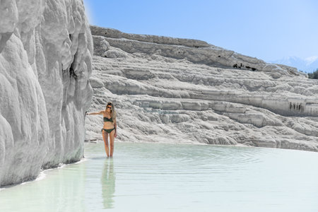 Blonde pretty woman with swimwear at Natural travertine pools and terraces in Pamukkale Turkeyの写真素材