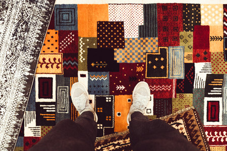 Pov section of legs on the carpet shop in Turkey