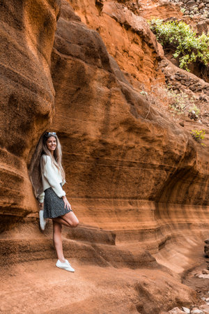 Blonde woman in the canyon of Barranco de las Vacas in Gran Canariaの写真素材